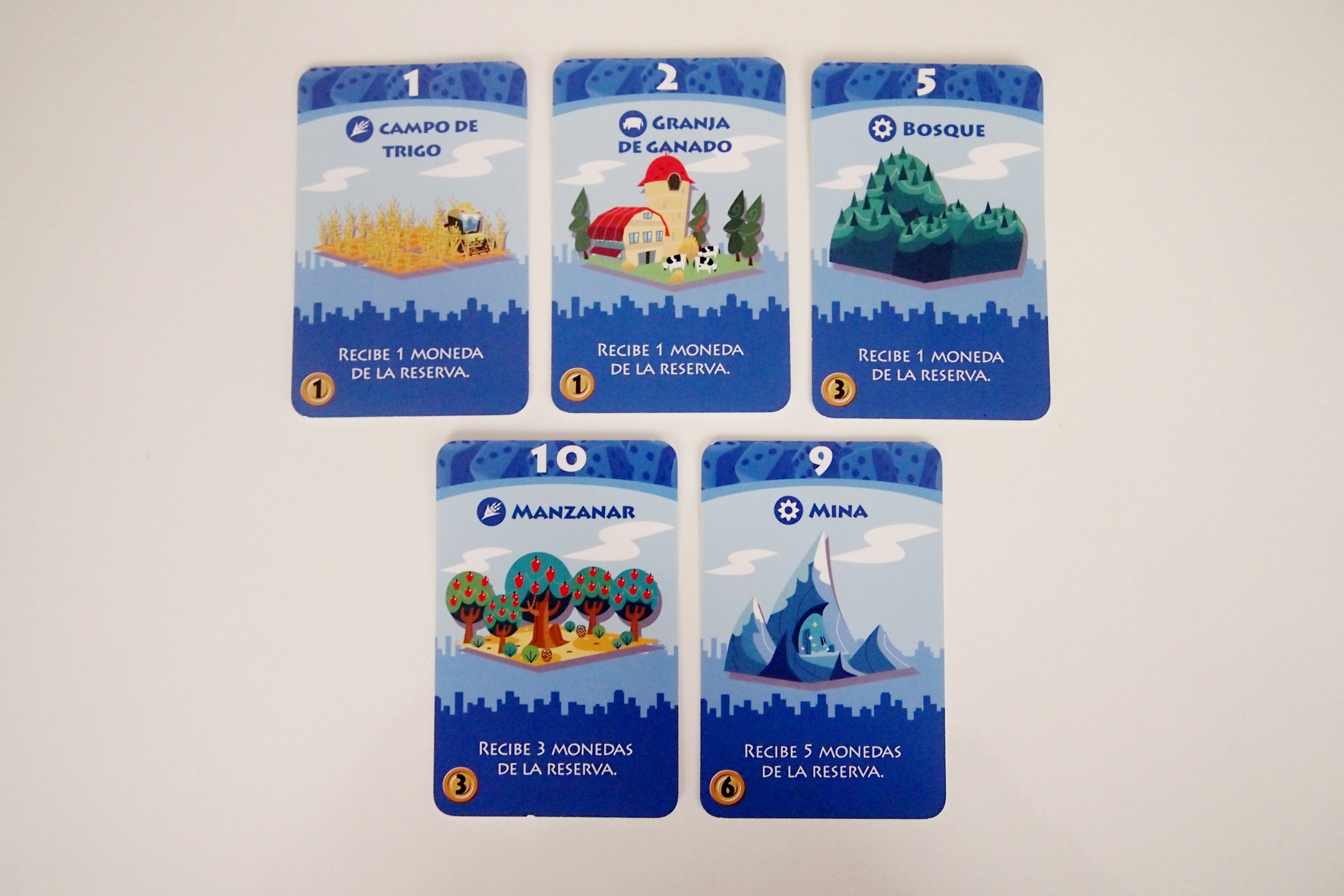 Los edificios azules proporcionan monedas de la reserva en el turno de cualquier jugador. 